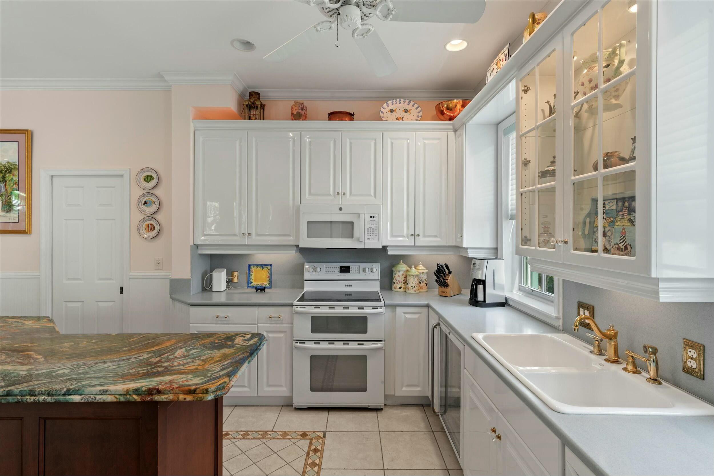 68 Sunset Key Drive Key West, FL 33040 - Photo 28 of 69 a kitchen with stainless steel appliances granite countertop a sink stove and refrigerator
