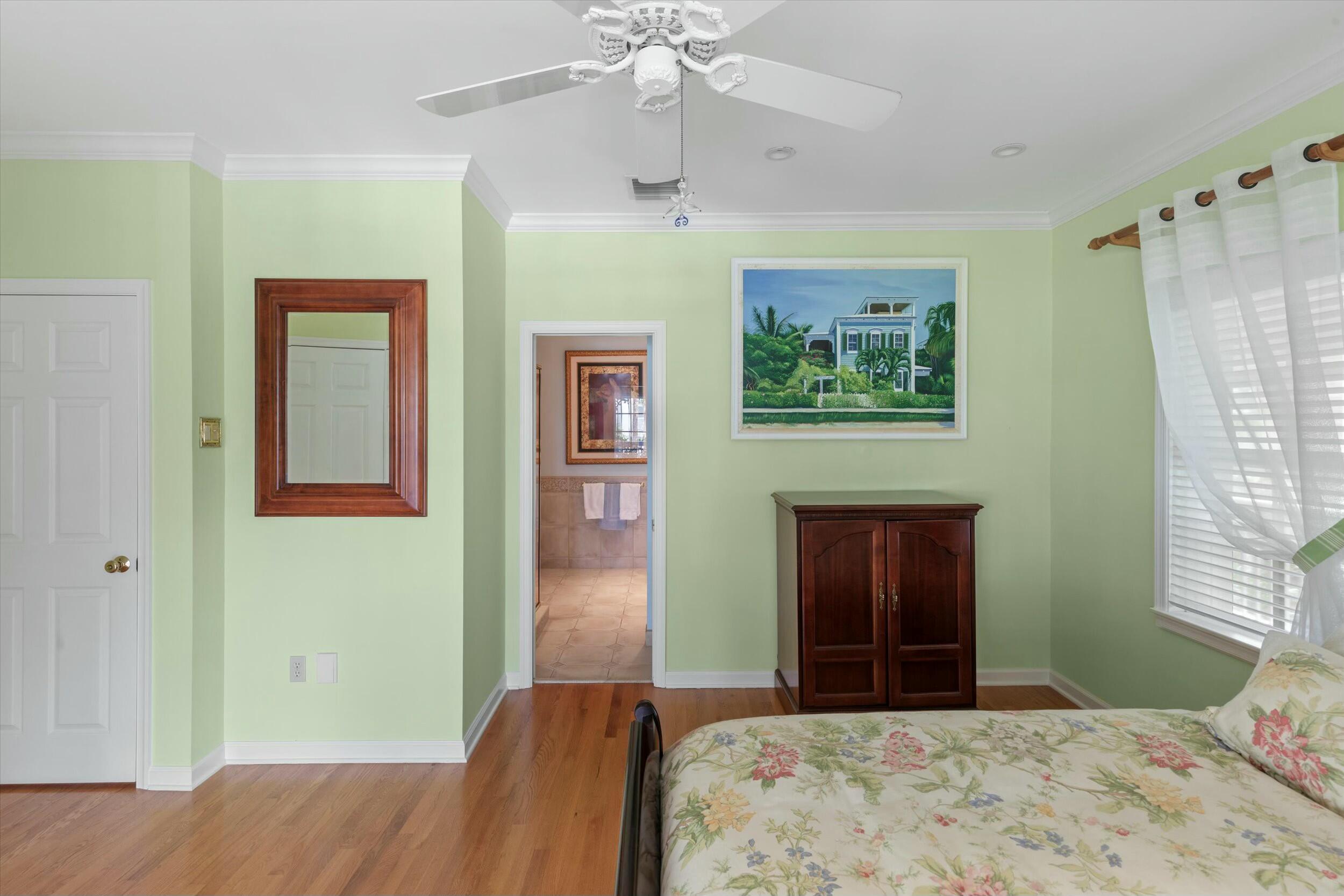 68 Sunset Key Drive Key West, FL 33040 - Photo 41 of 69 a bedroom with a bed and a painting on the wall