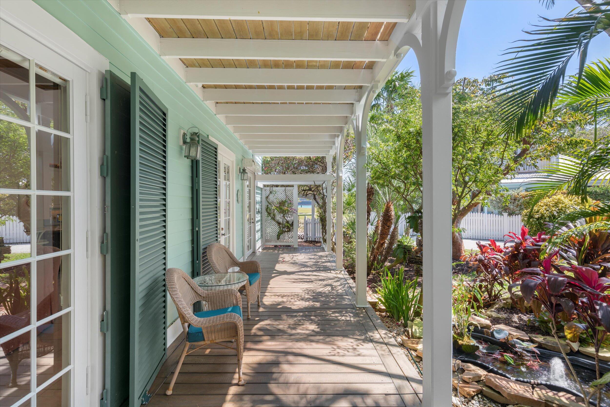 68 Sunset Key Drive Key West, FL 33040 - Photo 5 of 69 a porch with seating space and trees in the background