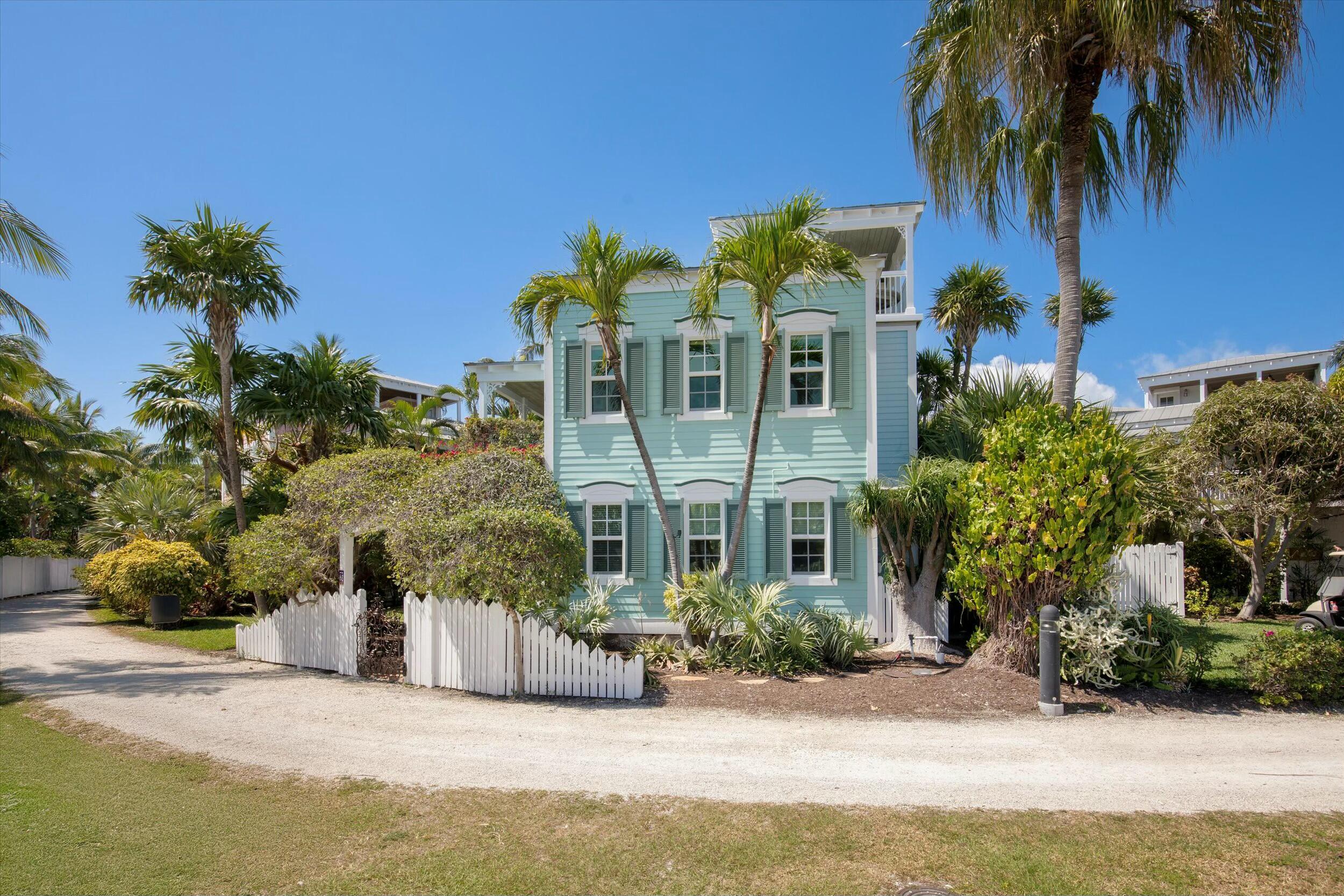 68 Sunset Key Drive Key West, FL 33040 - Photo 60 of 69 a front view of a house with a yard and a garage