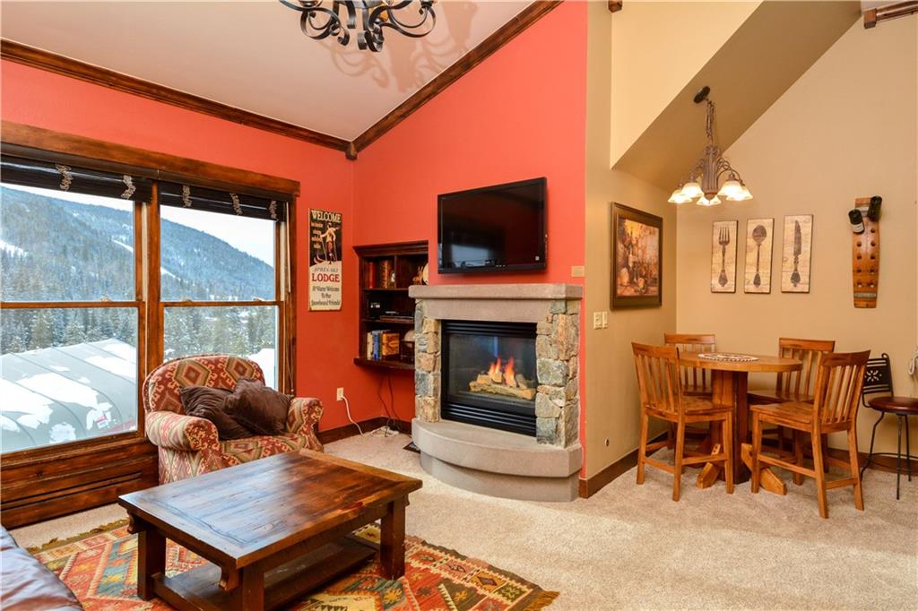 129 River Run Road, Unit 8073 Keystone, CO 80435 - Photo 1 of 16 a living room with furniture a flat screen tv and a fireplace