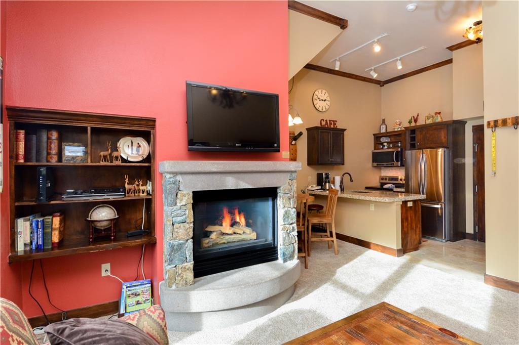 129 River Run Road, Unit 8073 Keystone, CO 80435 - Photo 2 of 16 a living room with furniture a flat screen tv and a fireplace