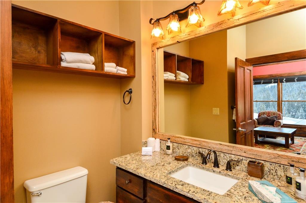 129 River Run Road, Unit 8073 Keystone, CO 80435 - Photo 11 of 16 a bathroom with a granite countertop sink and a mirror
