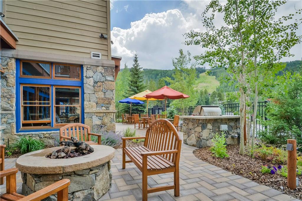 129 River Run Road, Unit 8073 Keystone, CO 80435 - Photo 14 of 16 a patio with a table and chairs under an umbrella