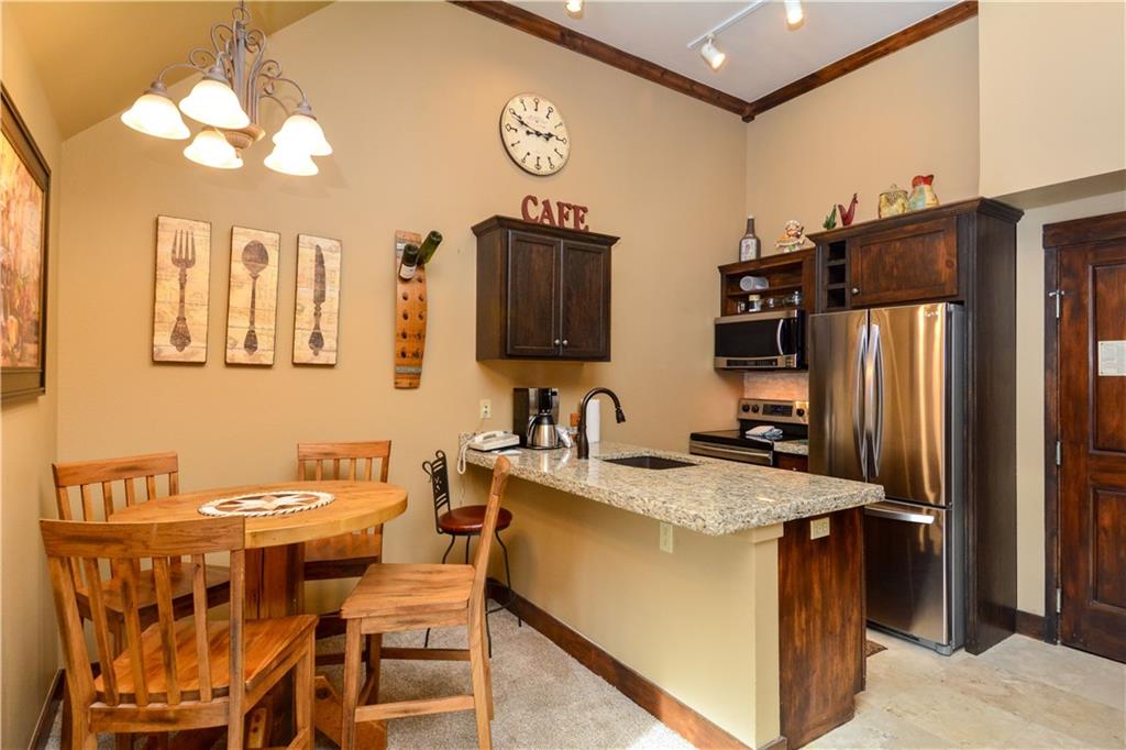 129 River Run Road, Unit 8073 Keystone, CO 80435 - Photo 3 of 16 a kitchen with a table chairs refrigerator and a sink
