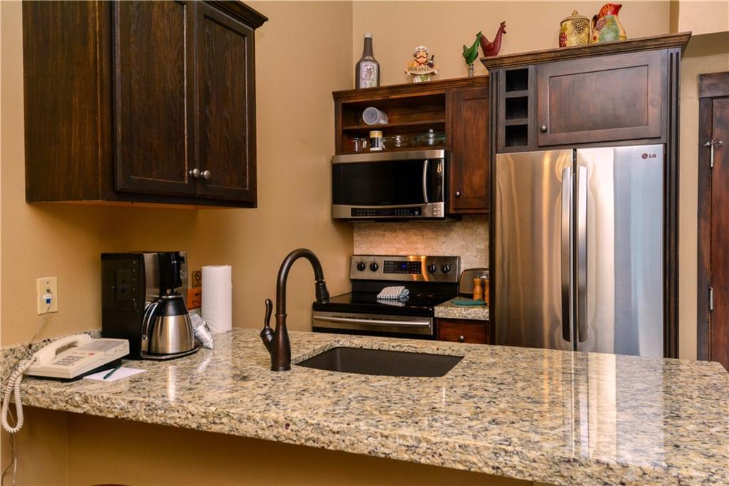 129 River Run Road, Unit 8073 Keystone, CO 80435 - Photo 4 of 16 a kitchen with granite countertop a refrigerator and a stove top oven