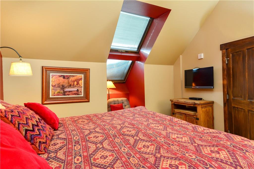 129 River Run Road, Unit 8073 Keystone, CO 80435 - Photo 8 of 16 a bedroom with a bed and a flat screen tv