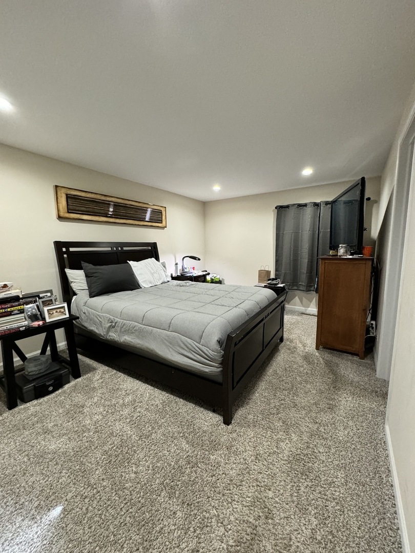 4279 Hilltop Road Long Grove, IL 60047 - Photo 16 of 21 a bedroom with a bed and a chair