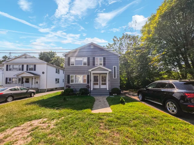 a view of a car parked in front of a brick house