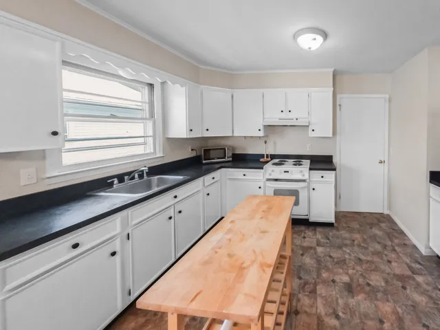 a bathroom with a sink a toilet and window