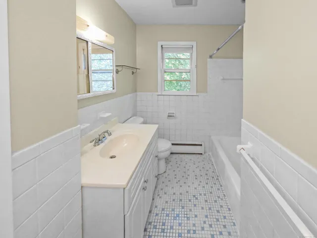 a bathroom with a toilet and shower