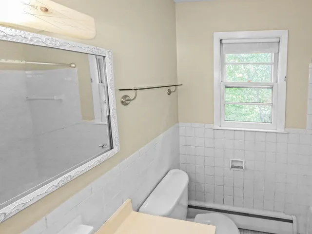 a bathroom with a tub sink a mirror and a shower