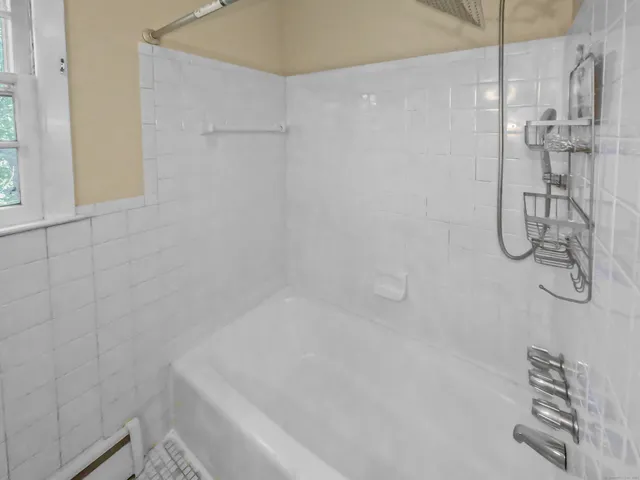 a bathroom with a shower and a sink