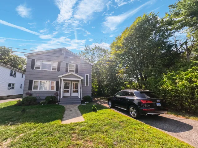 a view of a car parked in front of a brick house