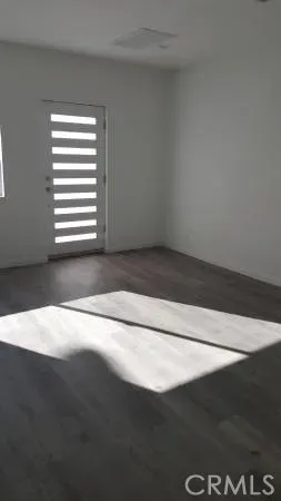an empty room with wooden floor