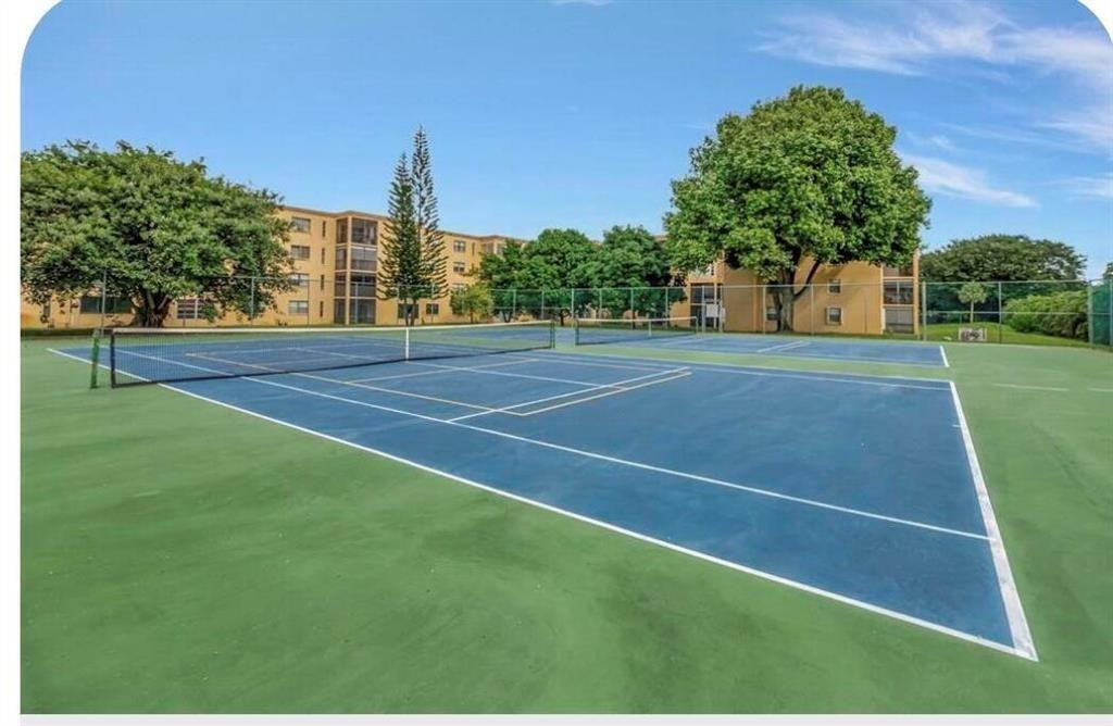 9273 Southwest 8th Street, Unit 109 Boca Raton, FL 33428 - Photo 19 of 20 a view of a tennis court