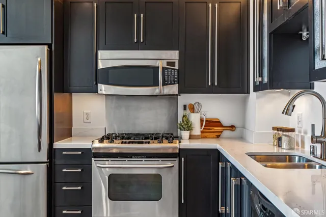 a kitchen with a stove microwave and sink