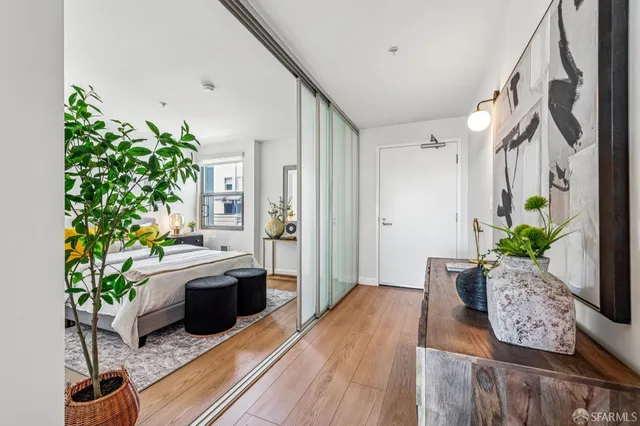 a living room with furniture potted plant and a wooden floor