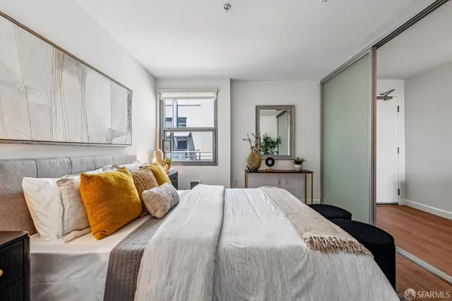 a bedroom with bed and a night stand