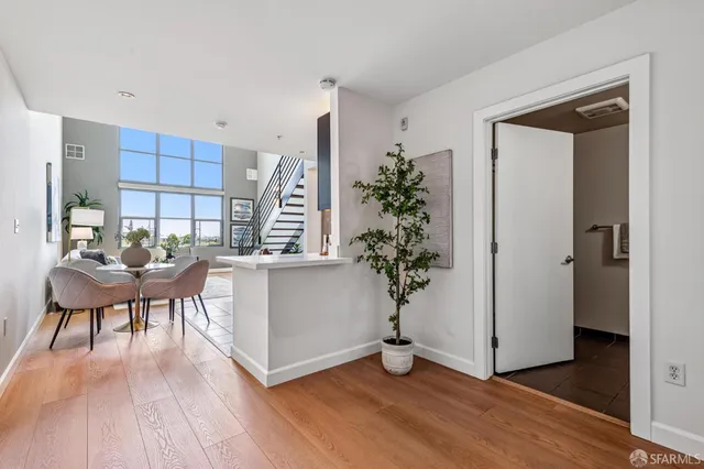 a living room with furniture and a potted plant