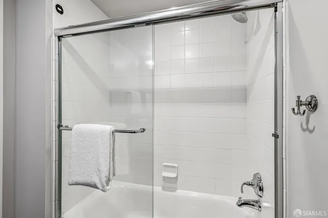 a bathroom that has a glass shower door