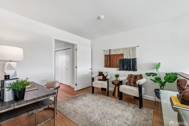 a living room with furniture and a potted plant