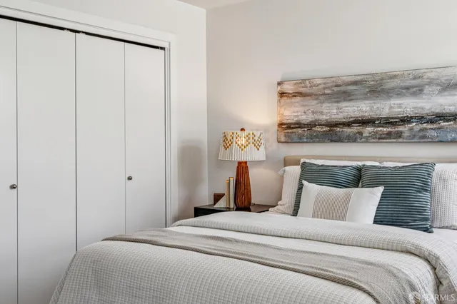 a bed room with a bed and a night stand