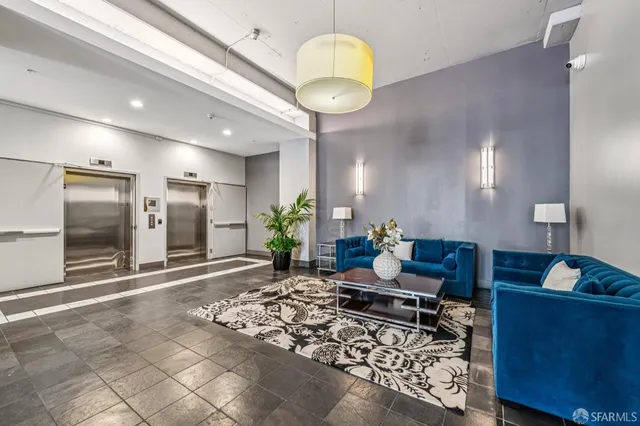 a living room with furniture and a chandelier