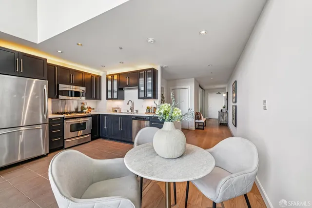 a large kitchen with a table and chairs