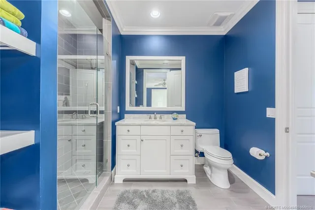 a large kitchen with a large counter top space a sink stainless steel appliances and cabinets