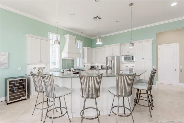 a kitchen with stainless steel appliances granite countertop stove top oven and cabinets