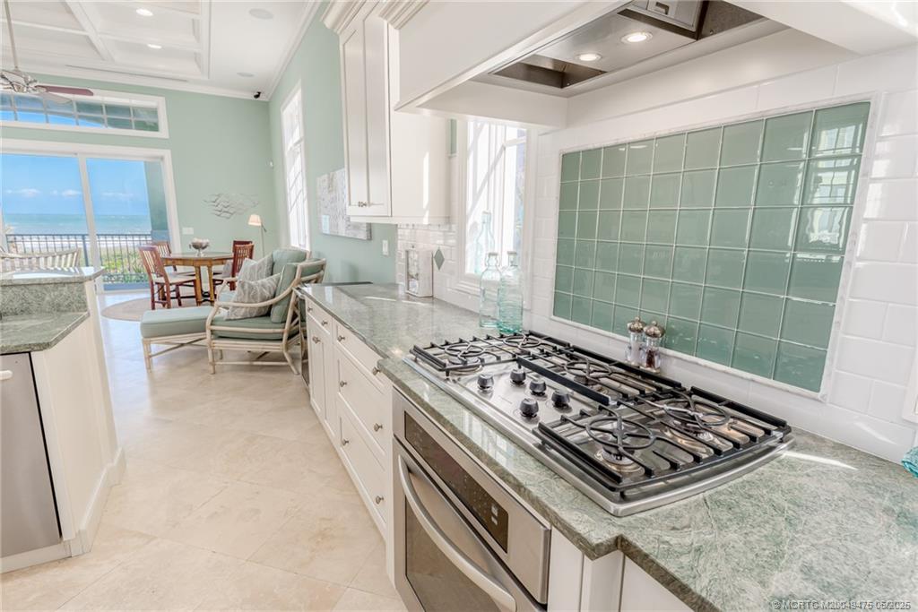 5032 Watersong Way Fort Pierce, FL 34949 - Photo 30 of 55 a large kitchen with a stove and white cabinets