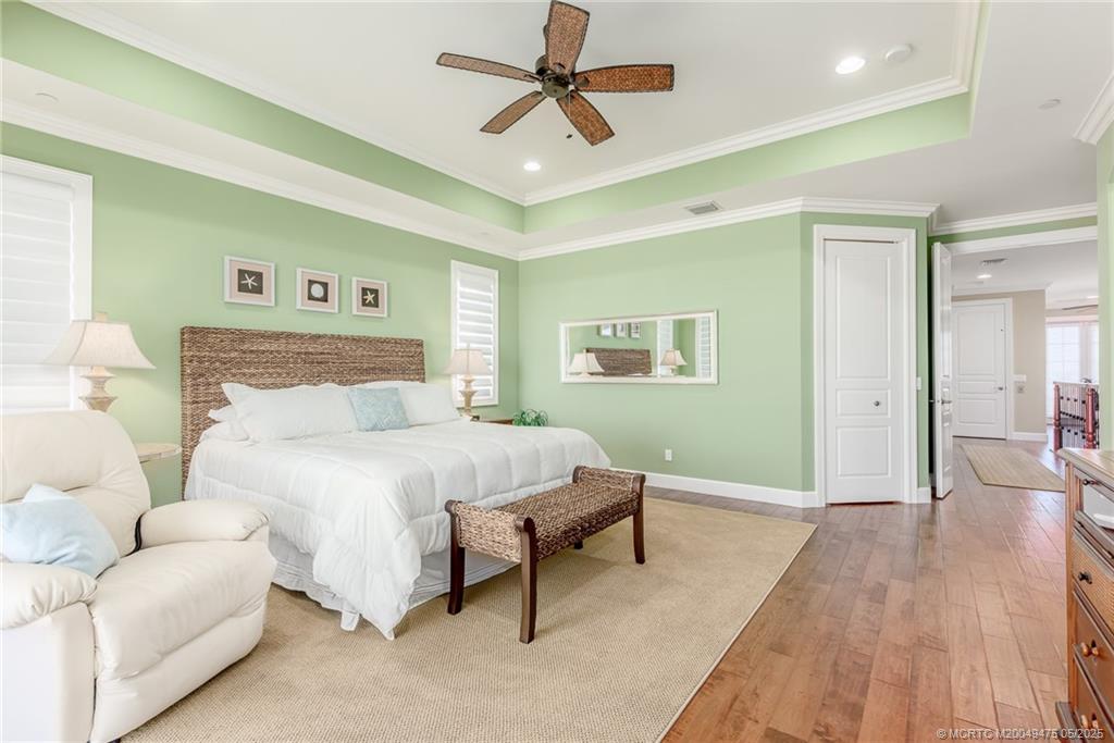 5032 Watersong Way Fort Pierce, FL 34949 - Photo 41 of 55 a spacious bedroom with a bed and a chandelier