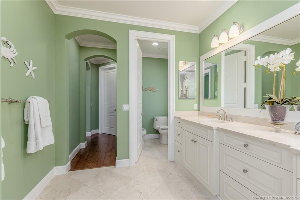 5032 Watersong Way Fort Pierce, FL 34949 - Photo 47 of 55 a spacious bathroom with a double vanity sink and a mirror