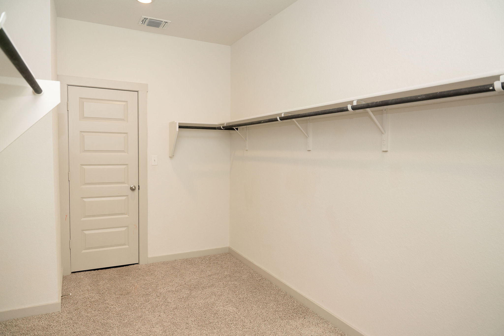 120 Wichita River Road Hutto, TX 78634 - Photo 19 of 31 Generous hanging rods and built-in shelving maximize storage space in this carpeted closet.