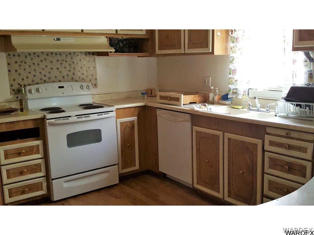 3370 Magma Road Golden Valley, AZ 86413 - Photo 9 of 17 a kitchen with a stove sink and cabinets