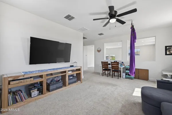 a living room with patio furniture and a floor to ceiling window