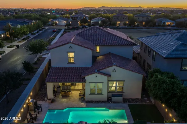 a view of a patio with couches and table and chairs under an umbrella