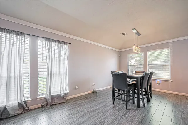 a view of a dining room with furniture and windows