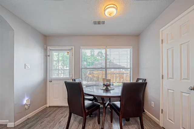 a view of a dining room with furniture and wooden floor