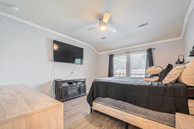 a bedroom with a bed and a flat screen tv