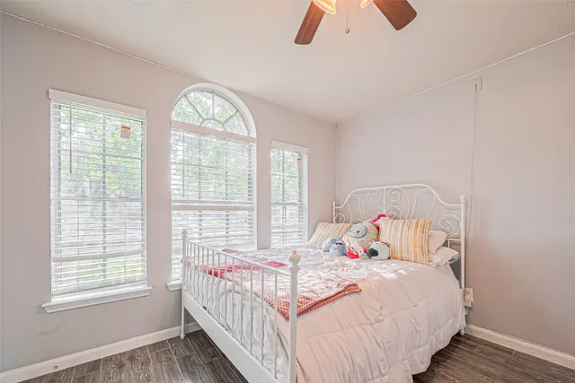 a bedroom with a large bed and a window