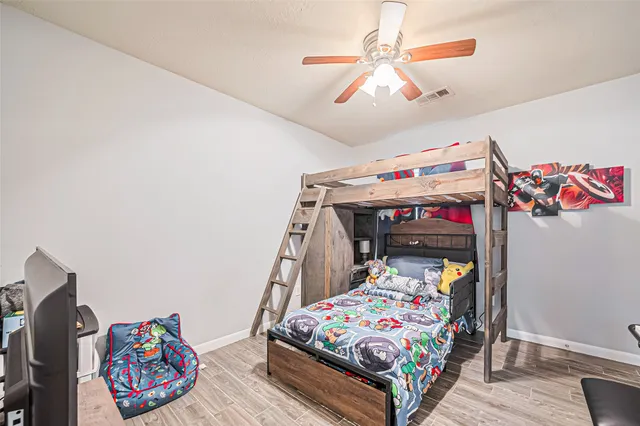 a bedroom with furniture and a baby crib