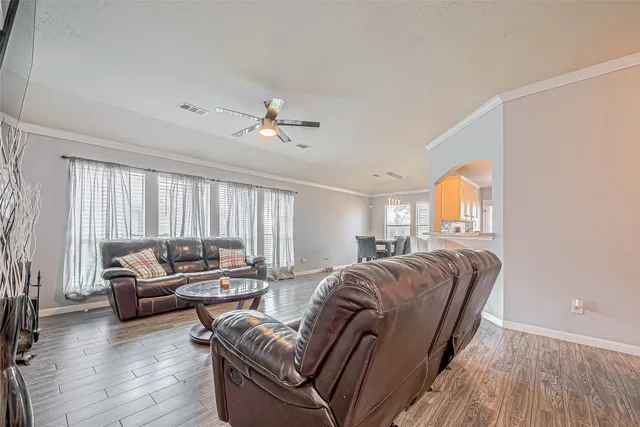 a living room with furniture window and a wooden floor