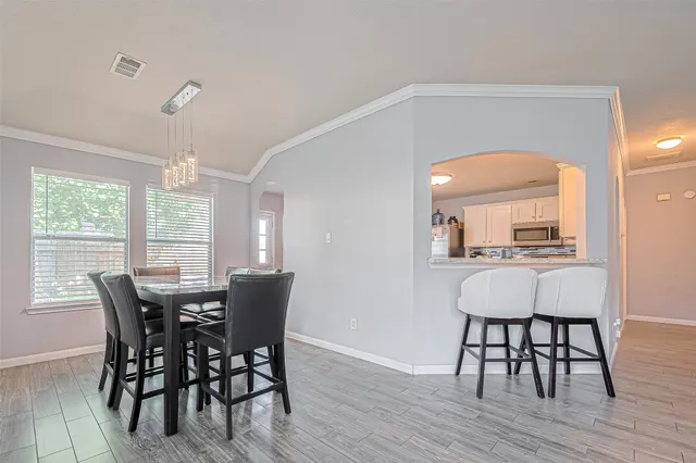 a view of a dining room with furniture and wooden floor