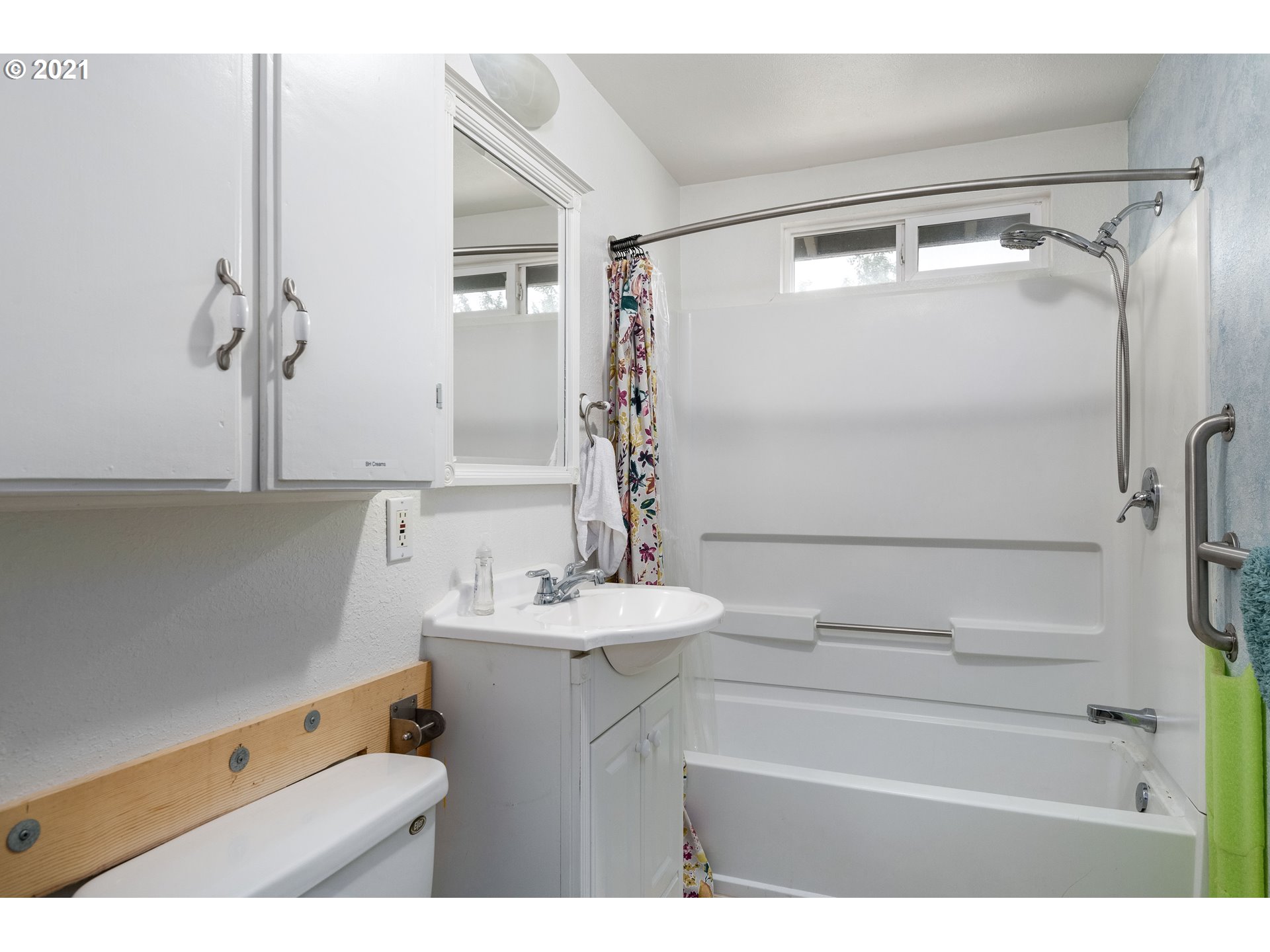 4954 E Street Springfield, OR 97478 - Photo 20 of 23 a bathroom with a sink mirror and a shower