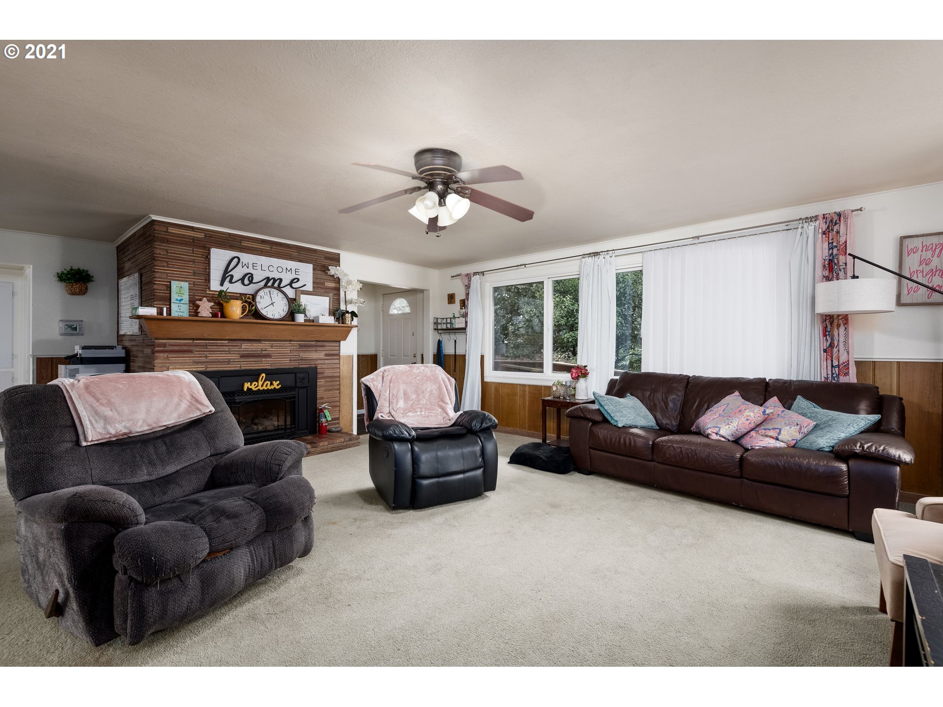 4954 E Street Springfield, OR 97478 - Photo 10 of 23 a living room with furniture a fireplace and a chandelier