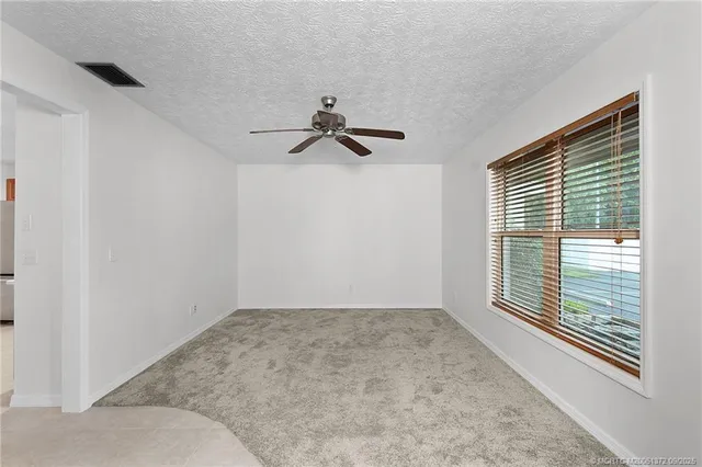 a view of room with a ceiling fan
