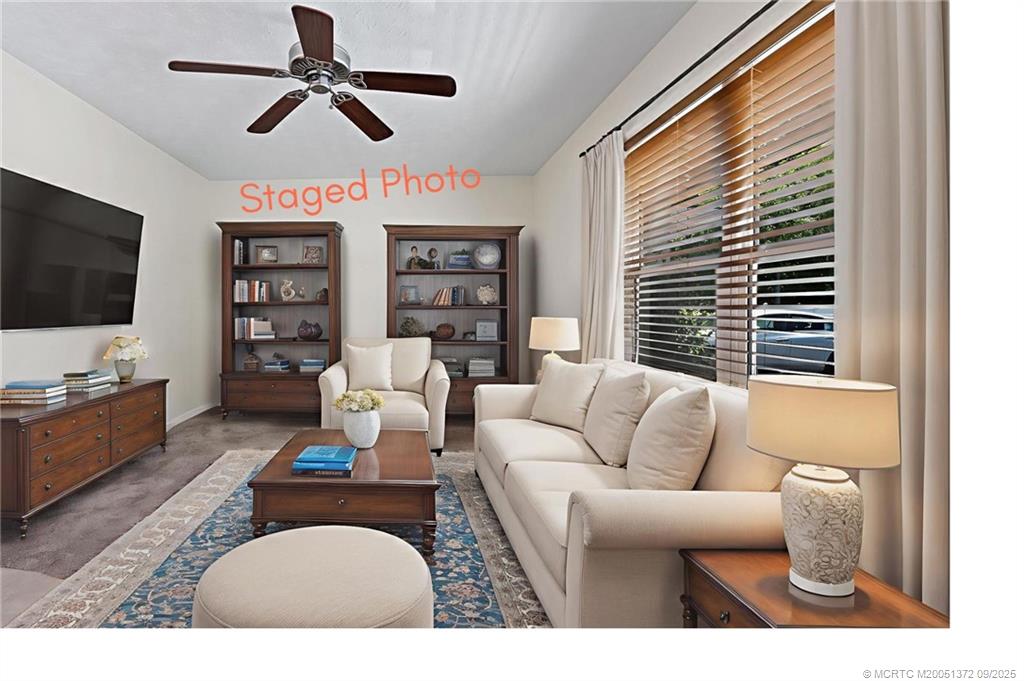 50 Southwest Blackburn Terrace, Unit 8 Stuart, FL 34997 - Photo 19 of 42 a living room with furniture a flat screen tv and a large window
