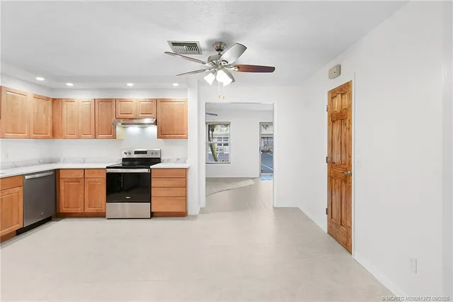 a kitchen with a refrigerator and a sink